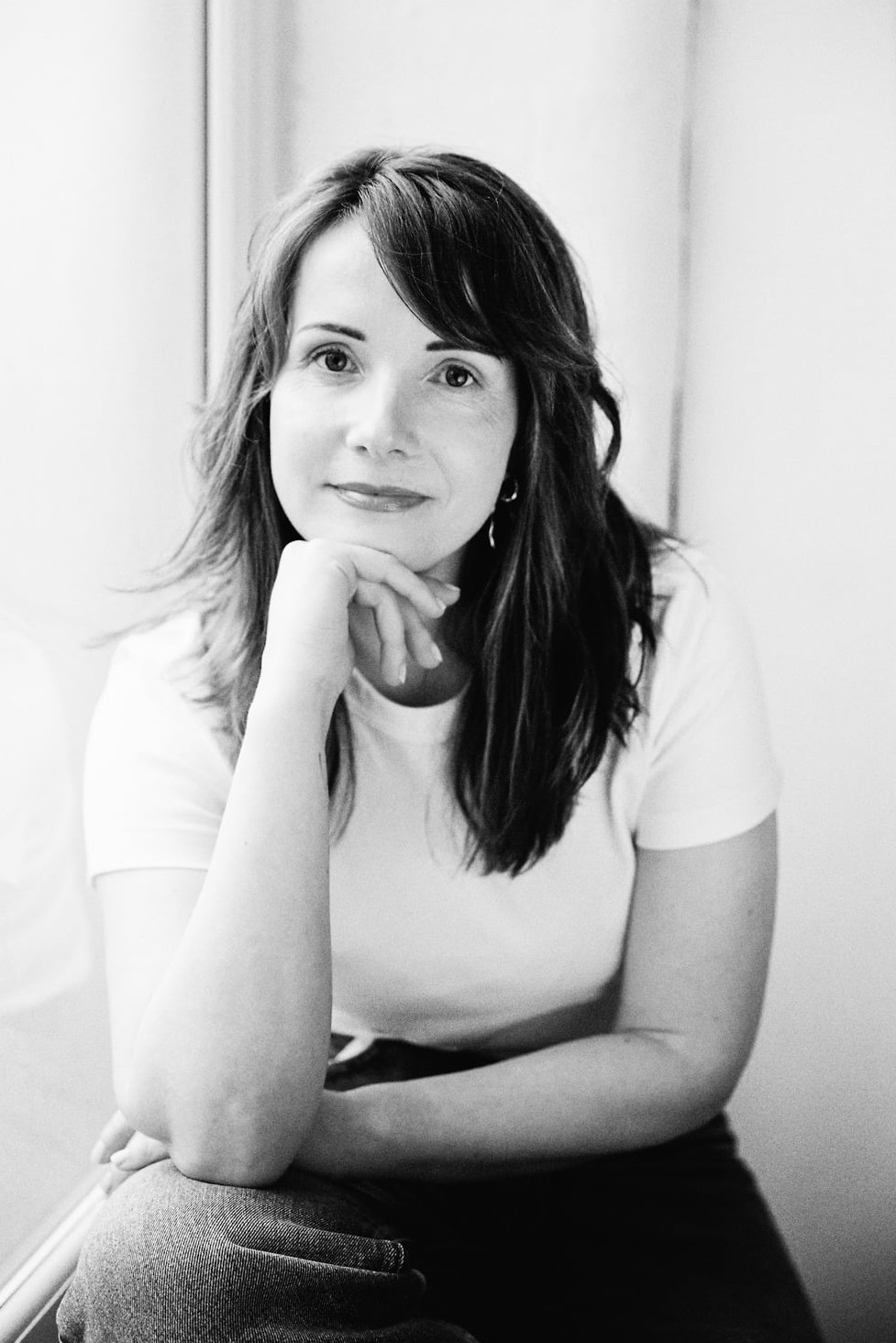 Laura McDermott resting her chin on her hand, in a thoughtful, reflective moment